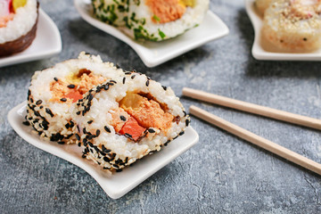 Sushi set on grey stone background.