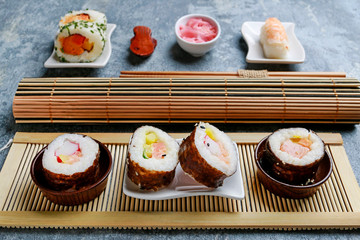Sushi set on grey stone background.