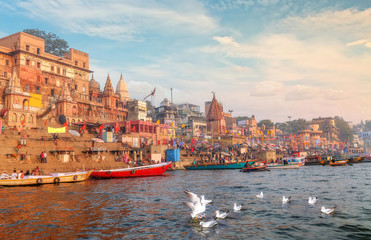Varanasi Ganges river ghat with ancient city architecture with view of migratory birds on river...