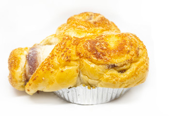 Buttered bread, sugar and stuffed with sausage on a white background