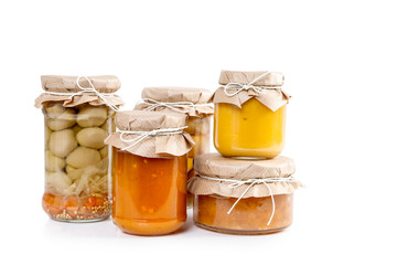Pickled vegetables and colorful jams in glass jars