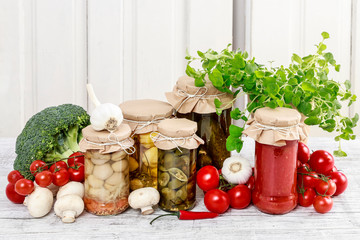 Jars of preserves and fresh vegetables.