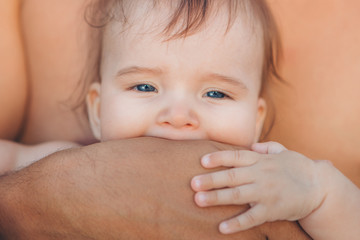 baby in the arms of the father. man holding a child