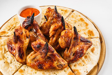 tasty grilled chicken wings with sauce