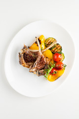 Modern French cuisine: Roasted Lamb neck & rack served with carrot, yellow curry and lamb sauce.