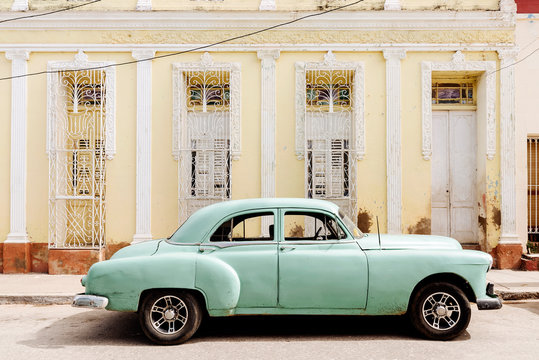 Vintage green car parked on street