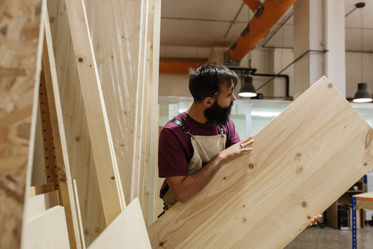 Man looking at wood in shop