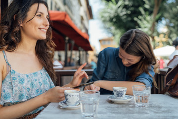 Young Beautiful Women Having a Coffee in Florence . Italy