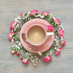 Cup of creamy coffee with flowers decor