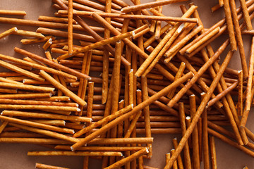 Crispy bread straw on brown paper background