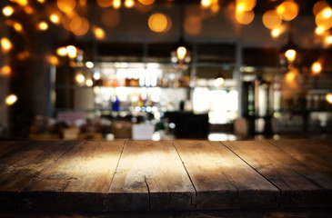 mage of wooden table in front of abstract blurred restaurant lights background