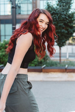 A teenage girl hanging out in the city at sunset