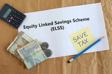 Equity linked savings scheme, elss, an Indian tax saving investment option, concept highlighted through text, Indian rupees and coins, a calculator and handwritten note.