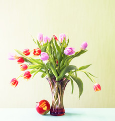 Bright tulips bouquet with red apple