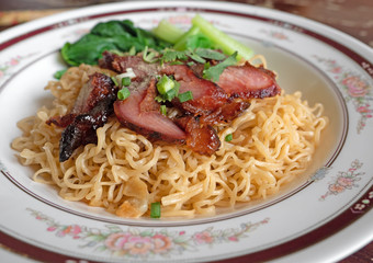 Close up Dry Egg Noodles with Red Roasted Pork and Green Bok Choy