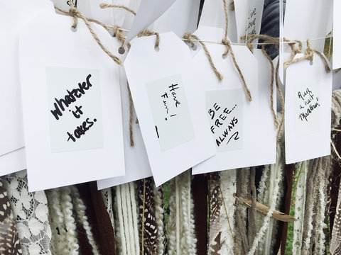 Row of positive notes hanging on line.