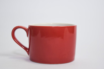 Close up hot cappuccino coffee in a red cup isolated on a white background