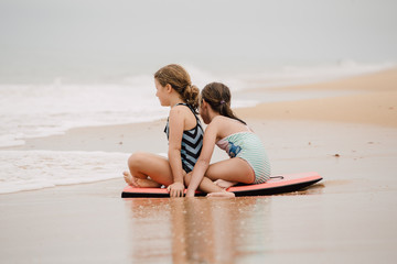 Girls playing in the shallow water on the beach