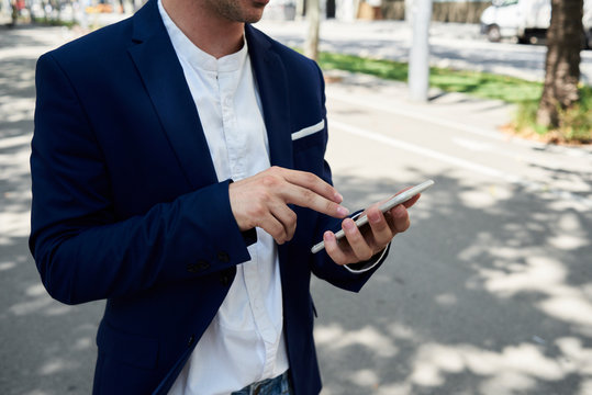 Entrepreneur checking data on the phone in the street.