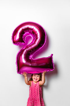 Baby Girl Holding a Number 2 Balloon for her Birthday