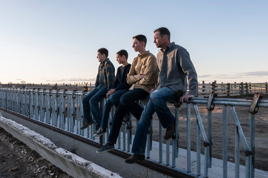 Father and sons together at sunset
