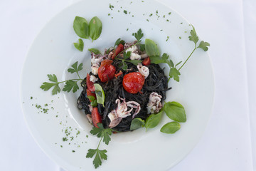 Black Squid ink Pasta with Baby Octopus, Food of Bocca di Magra Italy