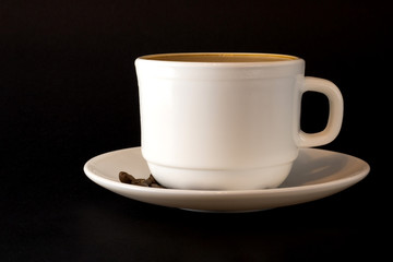 White cup of hot coffee isolated on black background.