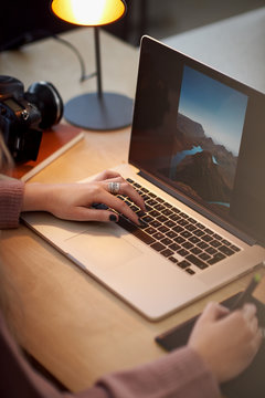 photographer retouching photos on laptop