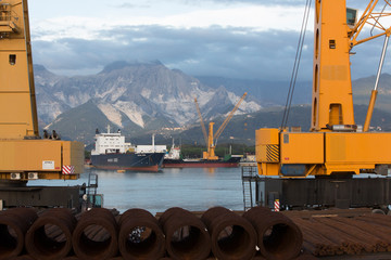 Marina di Carrara with cranes and view to marble quarries