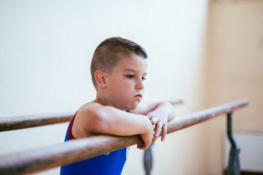 Gymnastics, young boy practicing on parallel bars