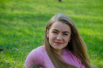 Portrait of a beautiful girl in bright pink clothes on a warm afternoon in the park