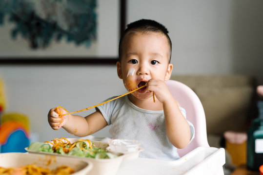 Adorable kid eating at home