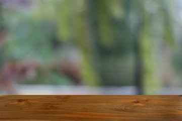 Empty dark wooden table in front of abstract blurred bokeh background of restaurant . can be used for display or montage your products.Mock up for space.