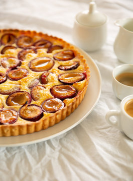 Plum custard tart served with coffee