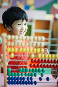 Young child with a colourful abacus