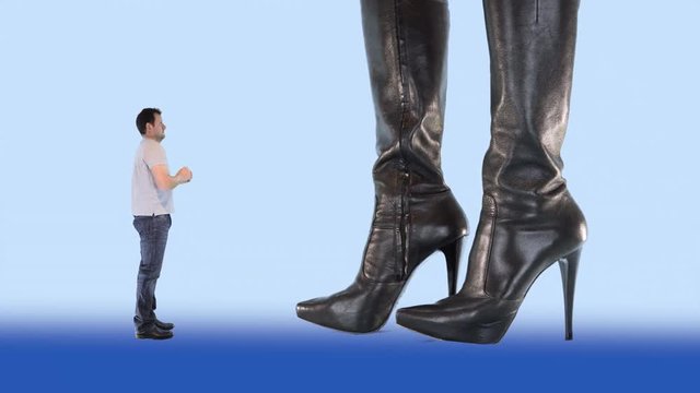 gigantic woman in stiletto boots kicks a man away