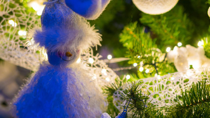 santa claus puppet hanging in christmas tree as decoration in a beautiful christmas tree