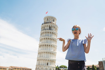 Happy child girl pointing Leaning Tower of Pisa