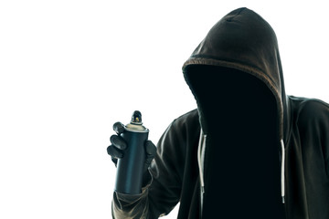 Hooded graffiti artist with spray paint can