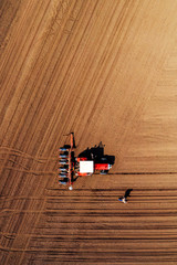 Aerial view of farmer and tractor with crop seeder