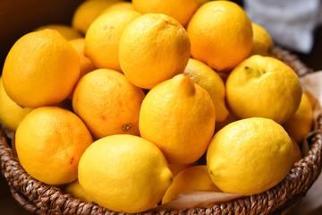 Yellow lemons in a wooden basket.Citrus in the basket