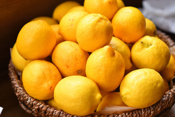 Yellow lemons in a wooden basket.Citrus in the basket