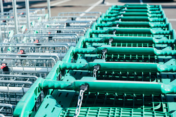 Line of green shopping carts in a supermarket
