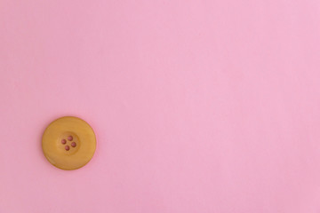 beautiful old retro button on pink background, short focus