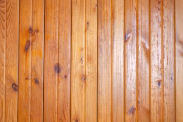grunge background: plank surface, varnished boards, yellow illumination on the right