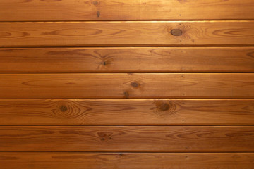 Fototapeta premium grunge background: plank surface, varnished boards, yellow lights on top