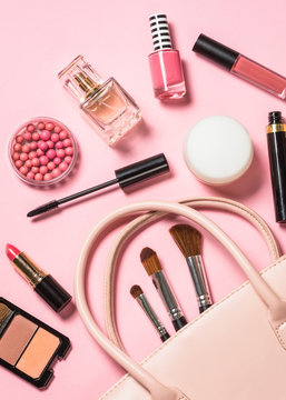 Woman flat lay makup background with cosmetics on pink.