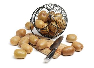 Whole and cut golden kiwifruit/ kiwi (Actinidia chinensis) on white background