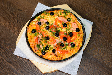 fast food, italian kitchen and eating concept - close up of homemade pizza on wooden table