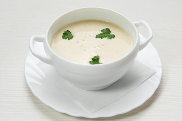 mushroom soup puree, in a plate, decorated with parsley, vegetarian dish